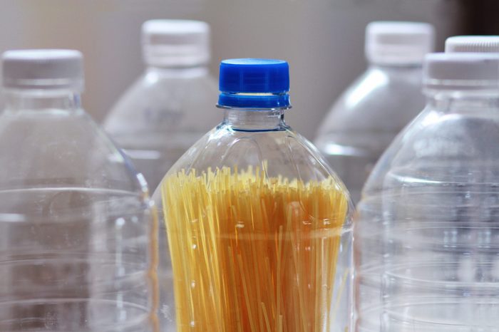D.I.Y pasta container.The ecology idea for reduce the amount of kitchen waste.Plastic water bottle used again by making it into a new pasta storage.Reuse reduce and recycle concept.