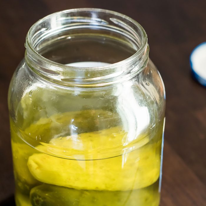 close up of an open pickle jar;