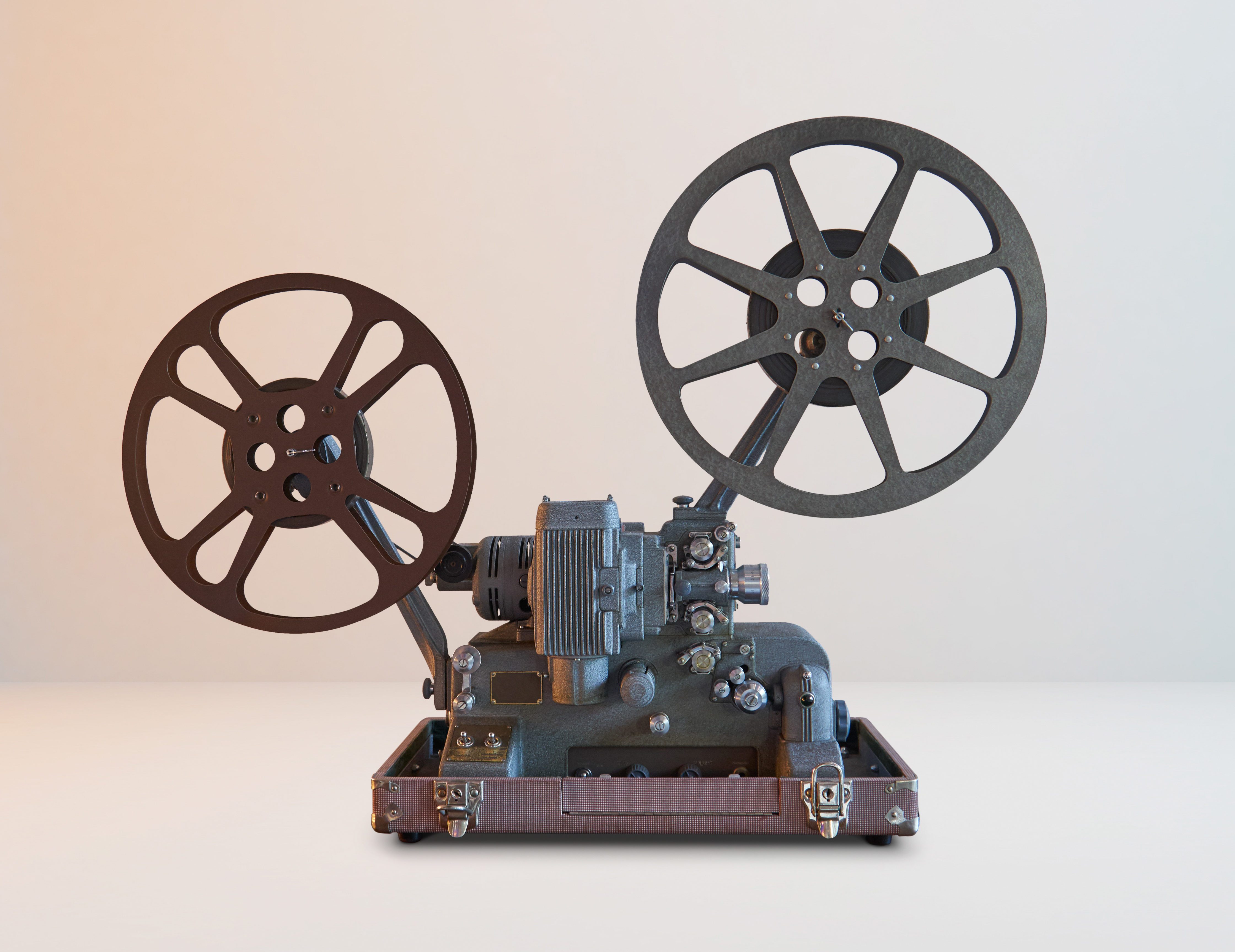 Old vintage cinema movie projector with white horizontal background .