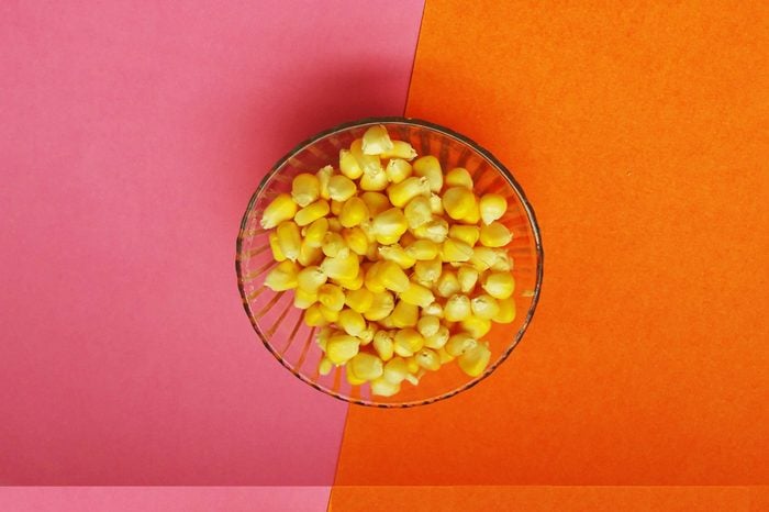 healthy raw sweet corn isolated on color background