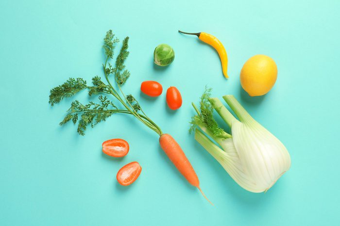 Flat lay composition with fresh fruits and vegetables on color background