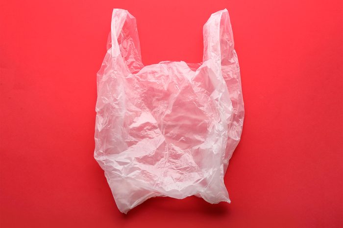 Clear disposable plastic bag on color background