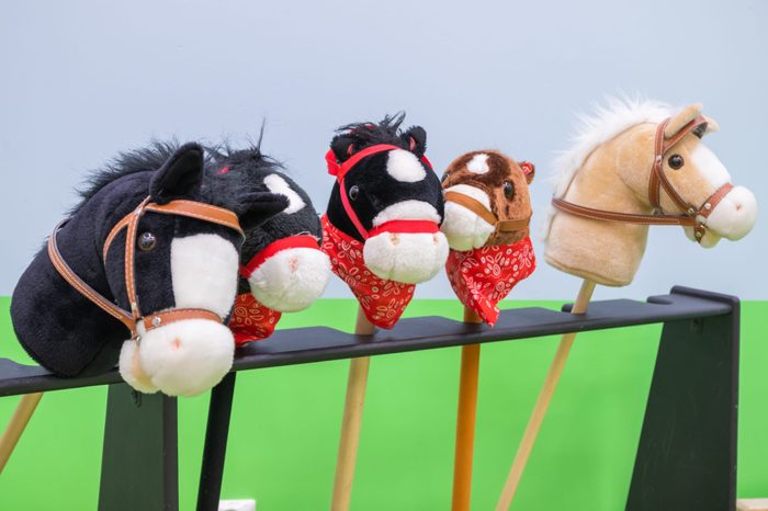 The row of multicolored hobbyhorses - children toys.