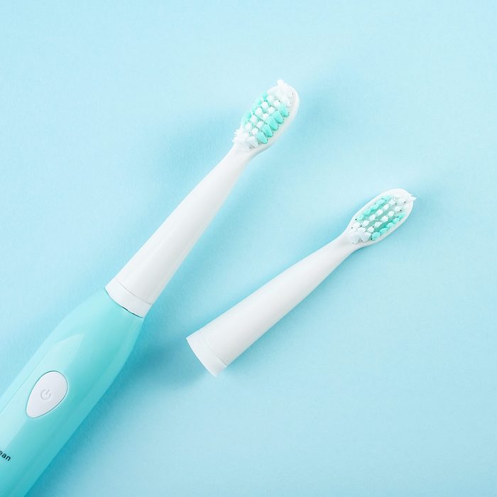 An electric toothbrush on a blue background