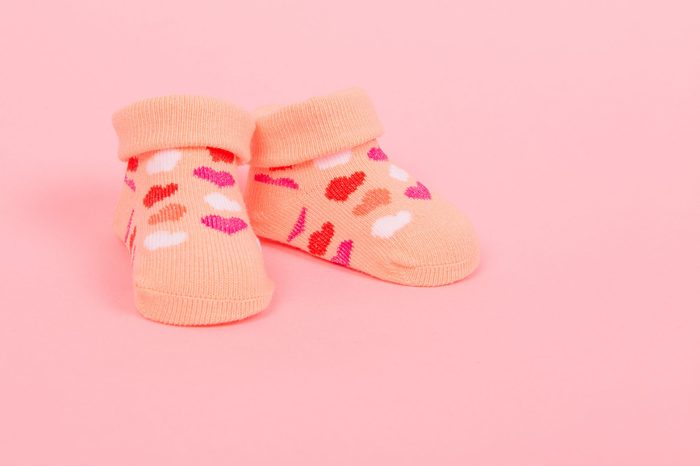 Baby socks with hearts on a pink background