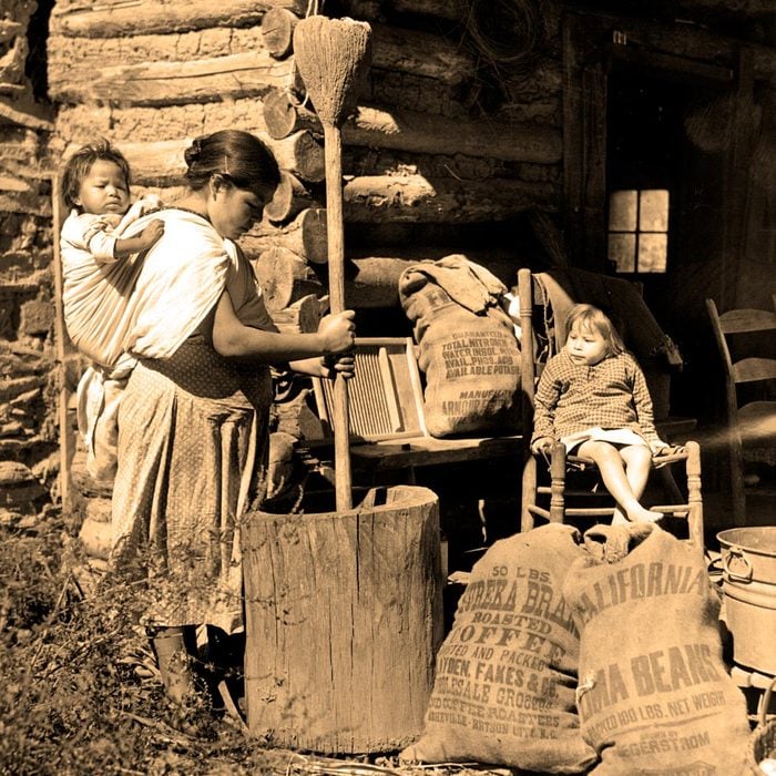 CHEROKEE INDIANS-Cherokee Indian woman cooking a meal on the Qualla Reservation in the Great Smokey Mountains.