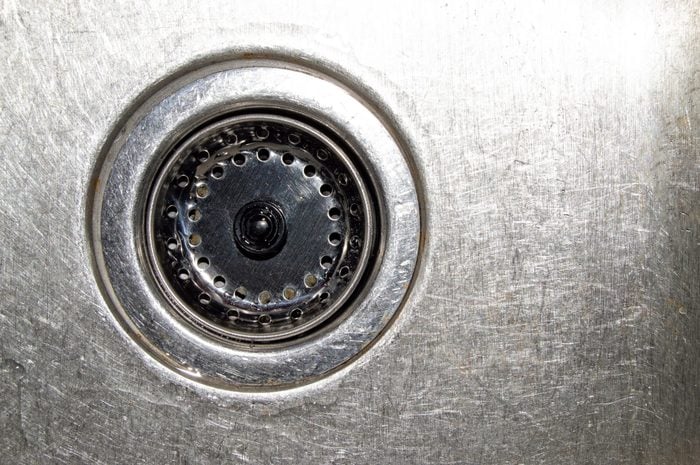 Close up overhead view of aluminum kitchen sink drain