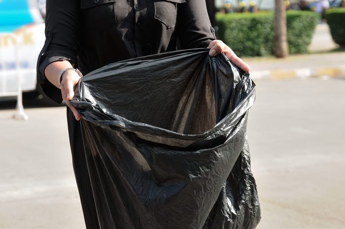 volunteers with black bags to collect garbage.