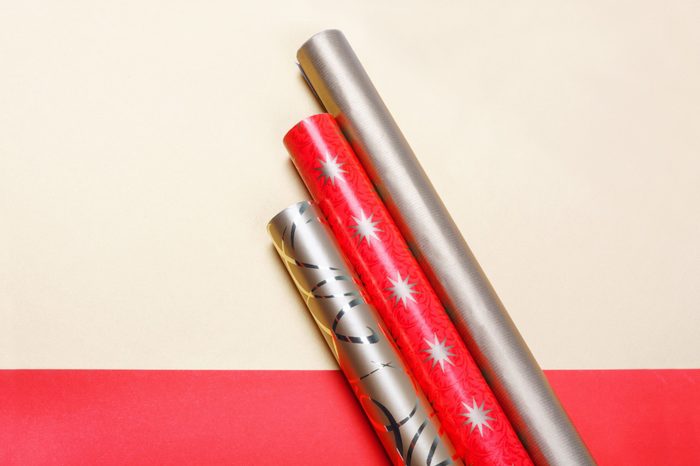 Golden and red wrapping paper on bright background.Top view flat lay group objects