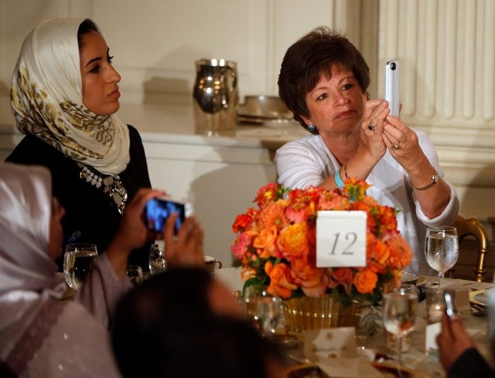 Mandatory Credit: Photo by Charles Dharapak/AP/Shutterstock (5945215a) Valerie Jarrett Senior adviser Valerie Jarrett, right, takes a photograph with her iPhone as President Barack Obama speaks as he hosts an Iftar dinner, which celebrates the breaking of fast during the Muslim holy month of Ramadan in the State Dining Room at the White House in Washington, . Obama also made comments about Syria and the Israel and Palestinian conflict Obama, Washington, USA