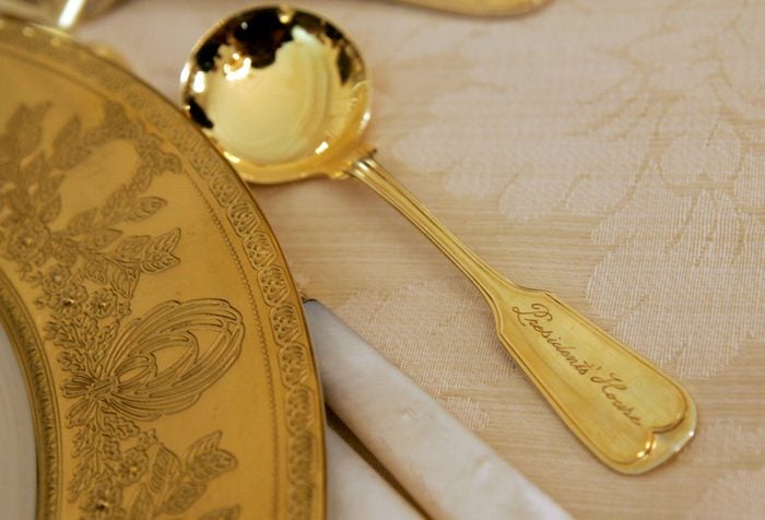 Mandatory Credit: Photo by Haraz N Ghanbari/AP/Shutterstock (5983652b) A spoon, engraved with the words "Presidents' House," that will be used for the State Dinner in honor of Queen Elizabeth II and her husband Prince Philip, is seen on a table in the State Dining Room of the White House in Washington Bush Royal Visit, Washington, USA