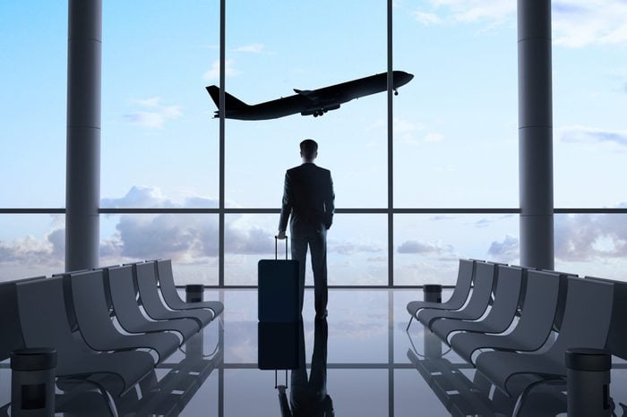 man in airport and airplane in sky
