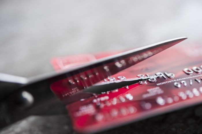 Credit card being cut with scissors, close up with copy space