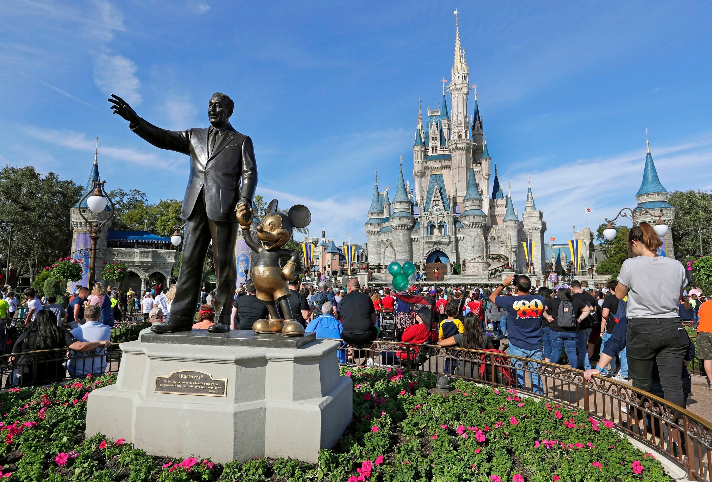 Mandatory Credit: Photo by John Raoux/AP/Shutterstock (10442147a) Guests watch a show near a statue of Walt Disney and Mickey Mouse in front of the Cinderella Castle at the Magic Kingdom at Walt Disney World in Lake Buena Vista, Fla. Disney World employees are easy targets. Tourists scream at them, sexually harass them and in the most serious cases, physically attack them, according to law enforcement reports Exchange-Disney Workers Abuse, Lake Buena Vista, USA - 09 Jan 2019