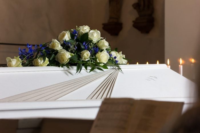 Coffin with a flower wreath in the church at a funeral