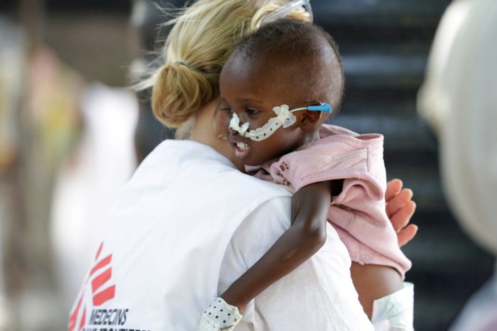 Jean Stowell, an American doctor from Loconia, New Hampshire, running the emergency operation, carries 18 month old Yakubu a malnourished child at a feeding centre run by Doctors Without Borders in Maiduguri, Nigeria.