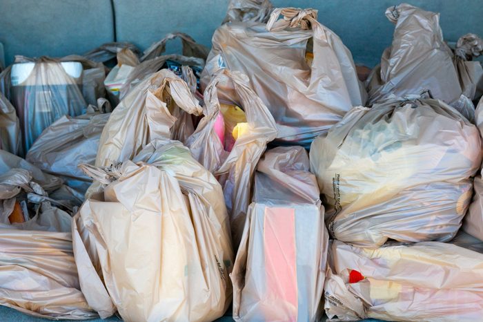 Plastic Bags full of groceries in the trunk