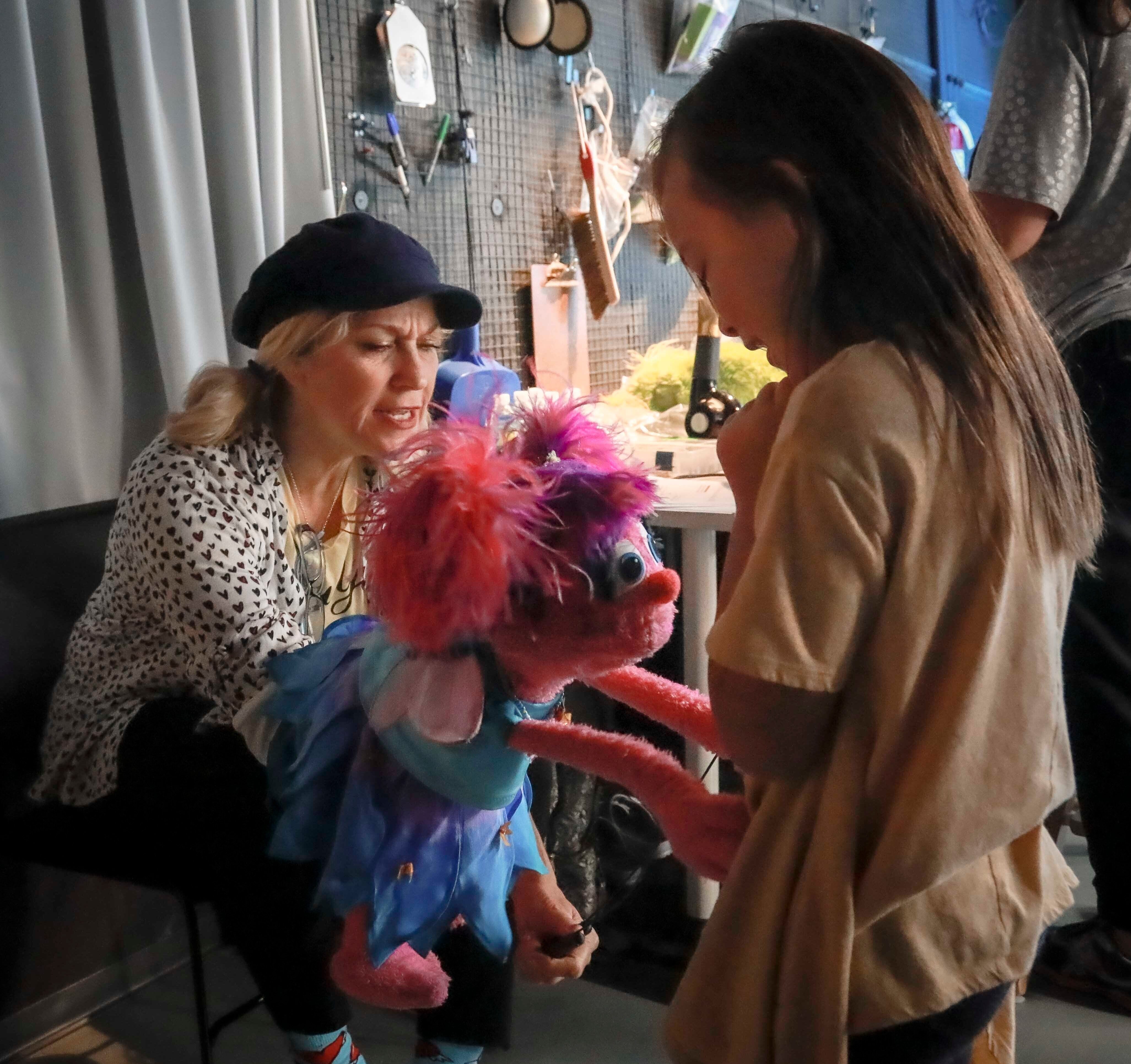 Mandatory Credit: Photo by Bebeto Matthews/AP/Shutterstock (10465504c) Puppeteer Leslie Carrara-Rudolph, left, performs her muppet "Abby Cadabby" for Kya Woodbury, 6, right, from Irvine, Calif., during a production break for the new Sesame Street Workshop show about parental addiction, "Sesame Street In Communities,", in New York. Kya's older sister Salia is featured in the new program, where she experiences of their parents struggle with addiction and recovery Sesame Street in Communities, New York, USA - 06 Aug 2019