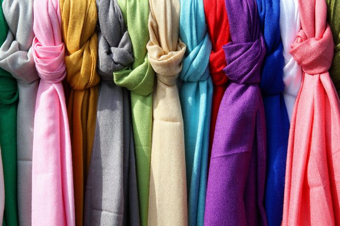 Colorful scarves at a market in Italy. Colors of textiles.
