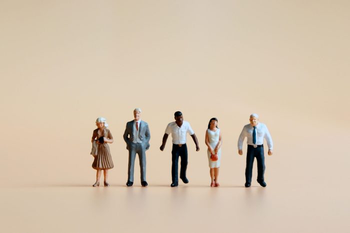 Various miniature people standing side by side.