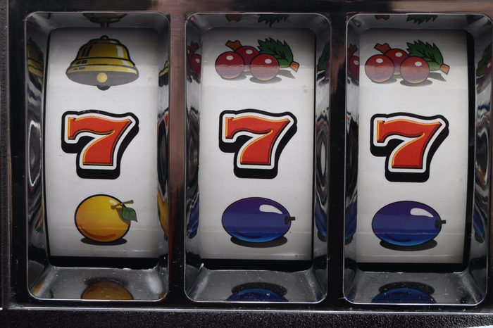 Casino slot machine, one-armed machine or fruit machine. Jackpot of triple seven on reels spins.