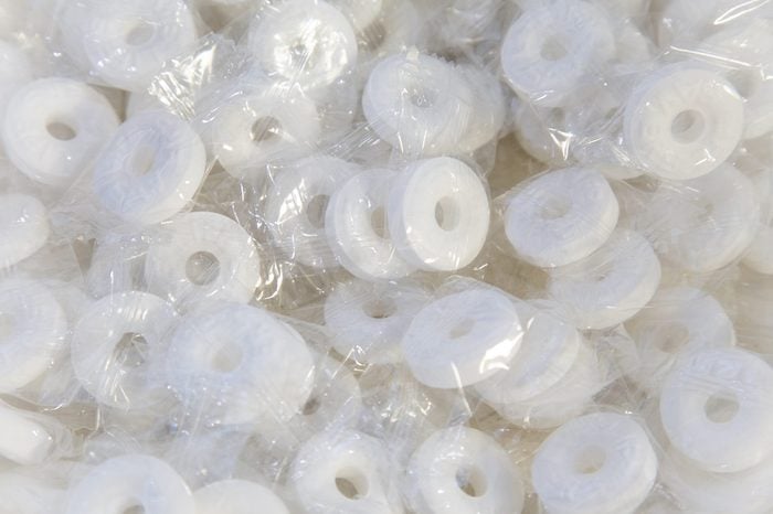 Closeup of white round mints inside individual clear packages