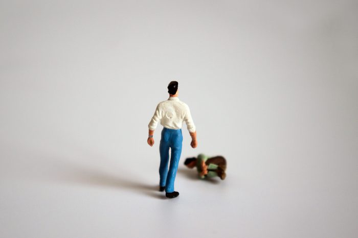 A miniature man is standing and a miniature woman is falling down