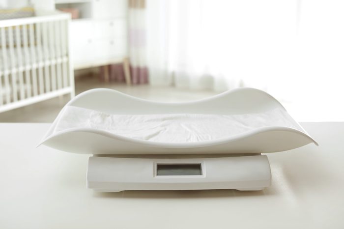 Modern baby scales on table in light room