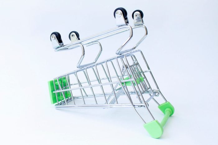 Empty shopping consumer store supermarket cart upside down on white background