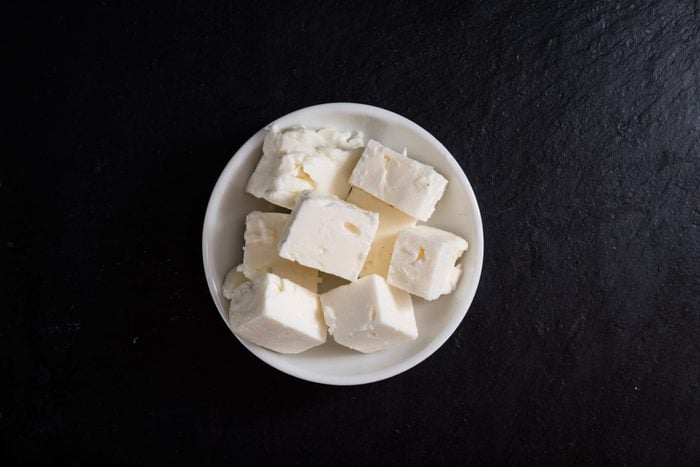 Portion of Feta Cheese on slate (selective focus, close-up shot)