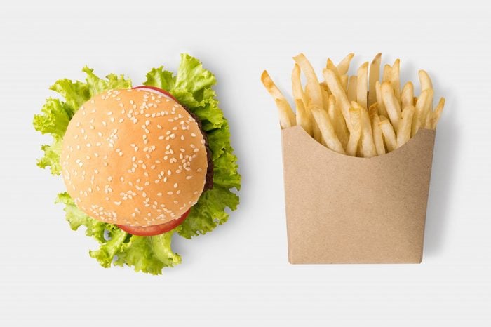 Concept of mock up burger and french fries on white background. Copy space for text and logo. Clipping Path included on white background.