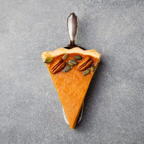 Pumpkin pie, tart made for Thanksgiving day. Grey stone background. Top view Copy space