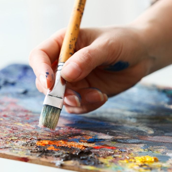 Artist paints a picture of oil paint brush in hand with palette close up.; Shutterstock ID 528643702; Job (TFH, TOH, RD, BNB, CWM, CM): Taste of Home