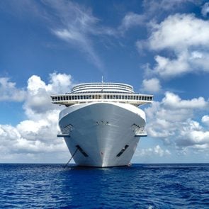 Cruise ship in crystal blue water with blue sky