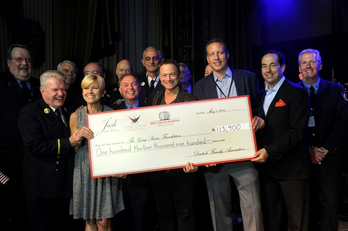 Peter Deutsch, third right, CEO, Deutsch Family Wine & Spirits, and Joseph Carr, second right, Founder, Josh Cellars, present a $113,900 check to actor Gary Sinise, center, and Judith Otter, second left, Executive Director, Gary Sinise Foundation, for their foundation after a concert by the Lt. Dan Band, in New York. Josh Cellars, a California wine brand, along with Deutsch Family and their distributor partners raised the funds for the Gary Sinise Foundation, which supports first responders, veterans and their families 5 May 2014