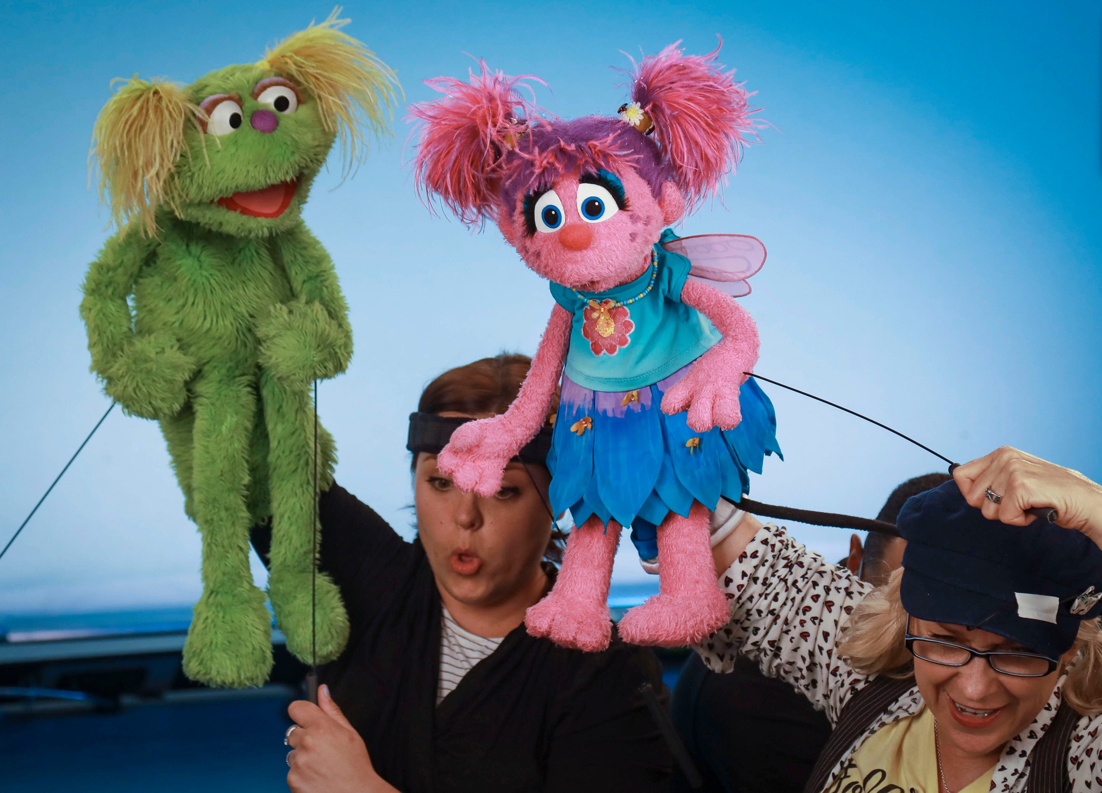 Mandatory Credit: Photo by Bebeto Matthews/AP/Shutterstock (10440203b) This photo shows puppeteers Haley Jenkins, left, and Leslie Carrara-Rudolph performing with their "Sesame Street" muppets Karli and Abby Cadabby, respectively, for segments about parental addiction in New York. Sesame Workshop is addressing the issue of addiction. Data shows 5.7 million children under 11 live in households with a parent with substance use disorder TV-Sesame Street-Addiction, New York, USA - 06 Aug 2019