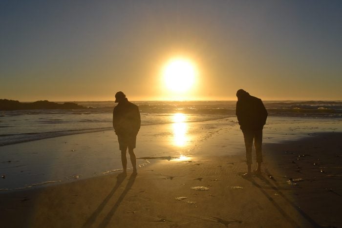 Two brothers silhouetted at sunset
