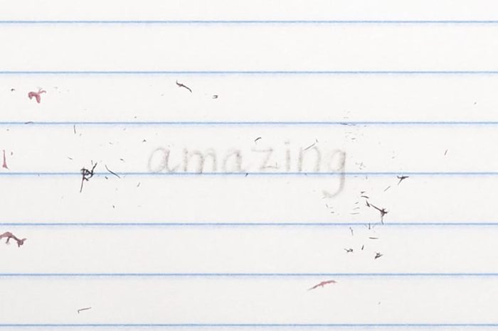 erased text "amazing" with eraser shavings on loose leaf paper