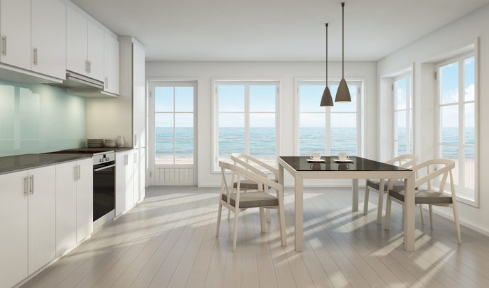 Sea view dining room and kitchen in beach house - 3D rendering