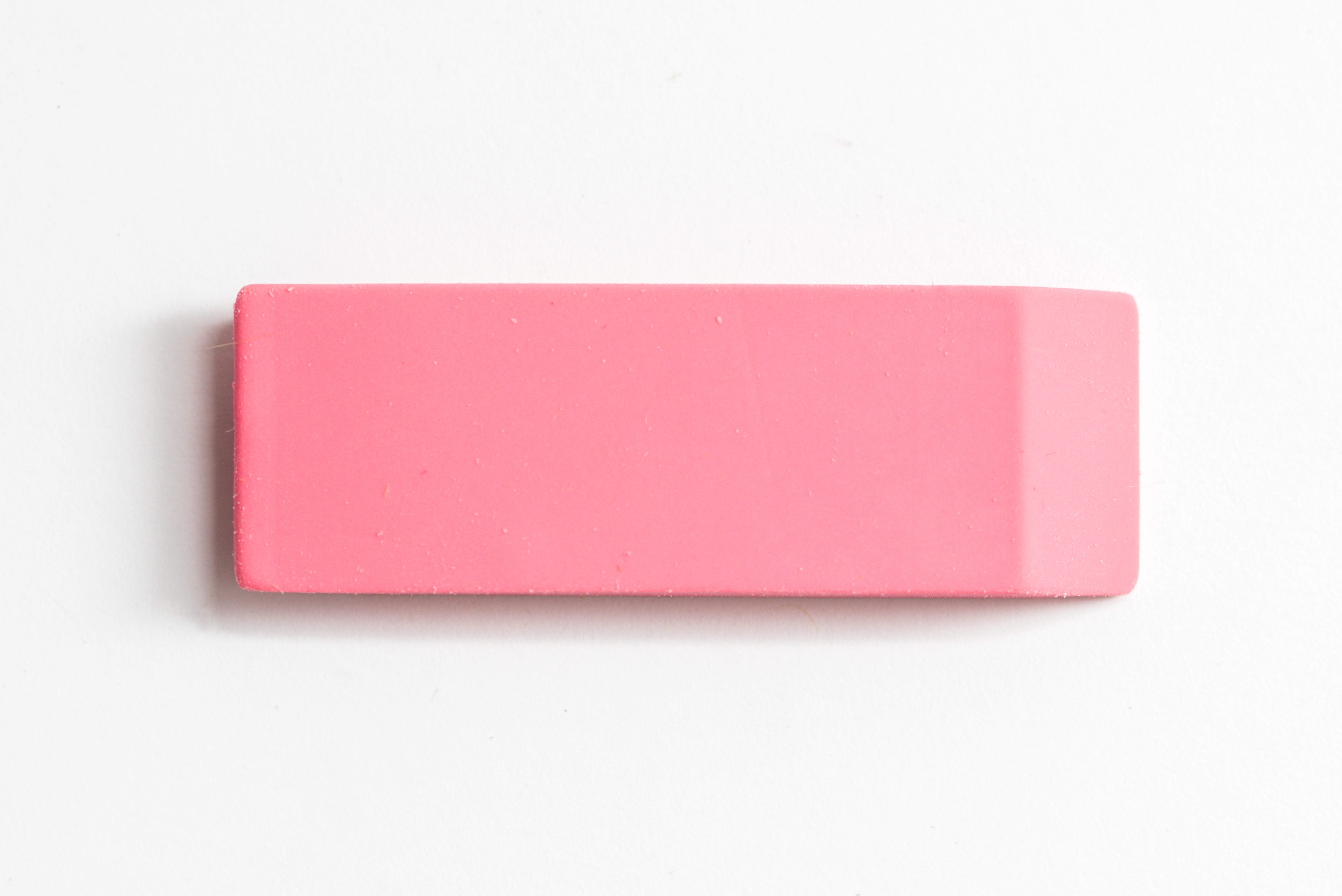 Pink eraser shot up close against a white background