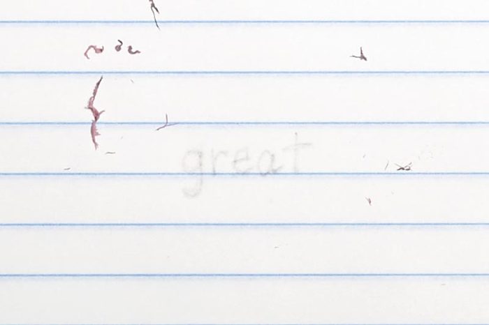 erased text "great" with eraser shavings on loose leaf paper