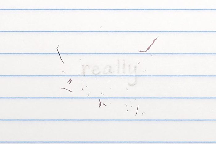 erased text "really" with eraser shavings on loose leaf paper
