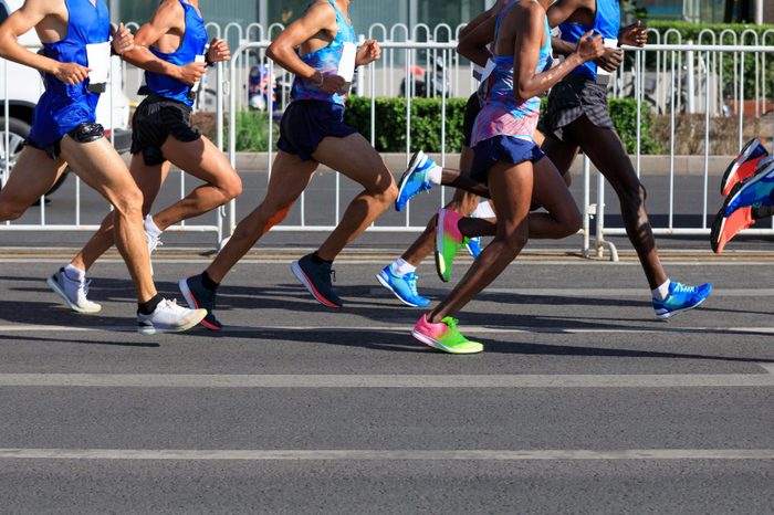 marathon runners legs running on city road