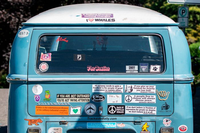 Volkswagen van with bumper stickers on it.