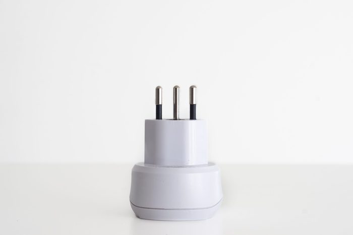 Power outlet adapter white with 3 pins swiss against white background