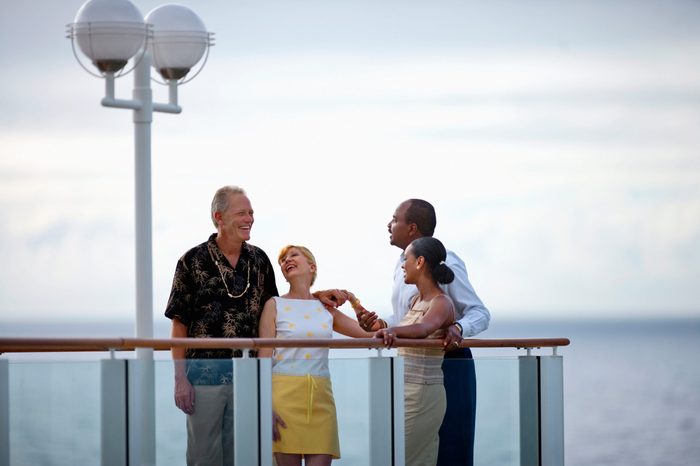 Two couples meeting on the deck of a cruise ship.