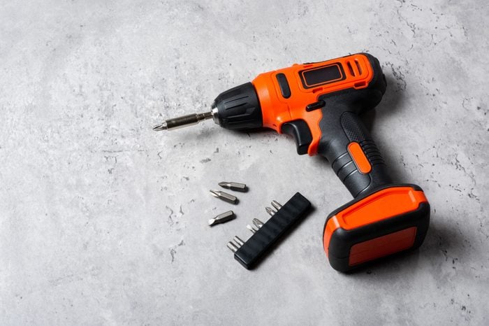 Black-orange cordless screwdriver drill. Power tool for construction and DIY.
