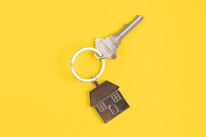Home key with house keyring or keychain on solid yellow background using as home ownership, mortgage or buy and sell property and real estate.; Shutterstock ID 1478922593; Job (TFH, TOH, RD, BNB, CWM, CM): -