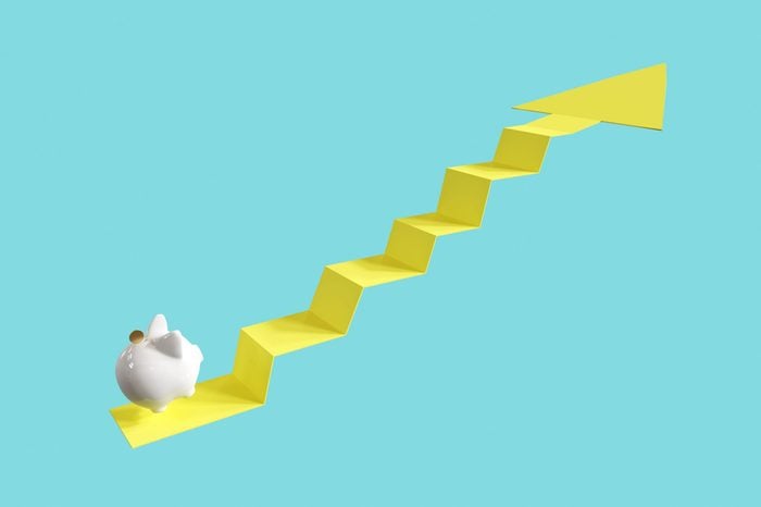 White Piggy Bank with coin Jump on Arrow Up. on Blue background. Minimal idea business concept. 3D rendering.