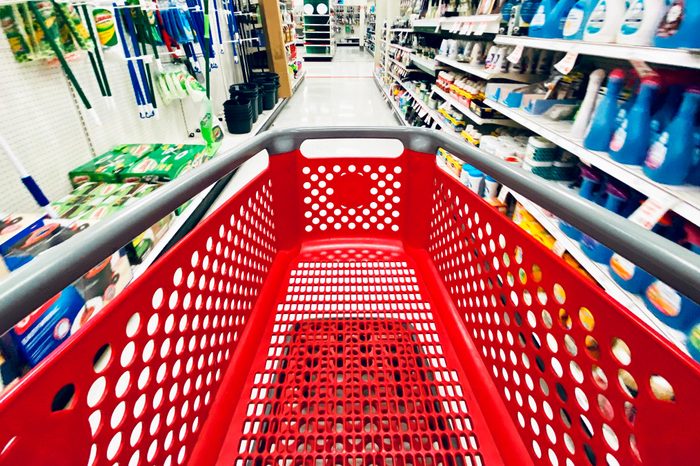 San Jose, CA - November 24, 2019: Motion blurred store shelves with wide view of the Target store red shopping cart in the center of the aisle.
